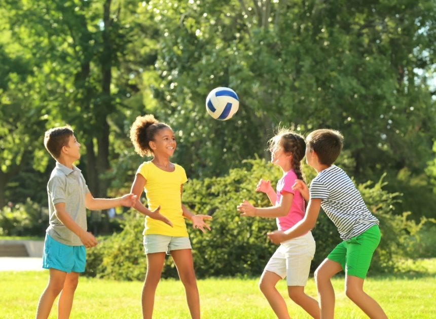 kids playing with soccer ball at summer camp